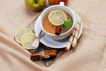 Tea with lemon, cinnamon sticks, tangerine