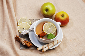 Tea with lemon, cinnamon sticks, tangerine