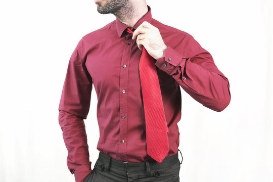 Businessman i red holding his tie 