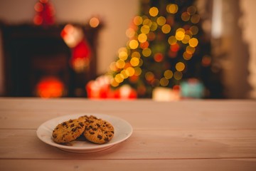 Cookies on desk with christmas tree in background