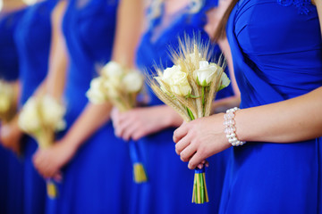 Row of bridesmaids with bouquets at wedding