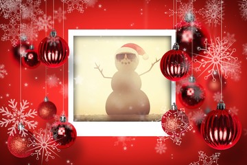 Composite image of festive sandman on the beach