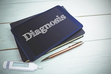 Obraz premium Diagnosis against view of a book and tablet lying on desk