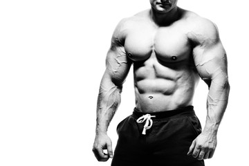 Handsome muscular bodybuilder preparing for fitness training. - obrazy, fototapety, plakaty