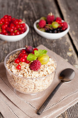 cereal and various berry for breakfast, close-up, vertical