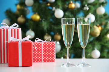 Glasses of champagne and Christmas gifts
