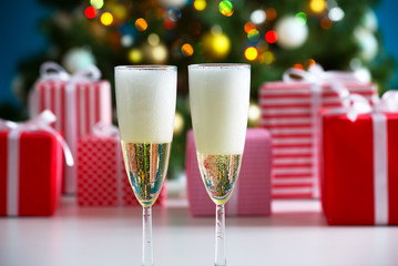 Glasses of champagne and Christmas gifts