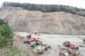 Excavator and heavy equipment in stone-pit