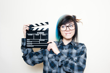 Smiling teen woman with clapper board