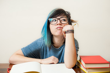 Young bored female student with book