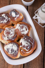 Homemade glazed cinnabons with cinnamon and almonds, american kitchen. Top view.