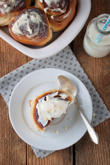 Homemade glazed cinnabons with cinnamon and almonds, american kitchen. Top view.