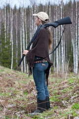 Woman hunter in spring forest