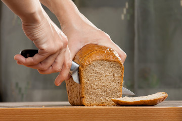 hands cutting bread