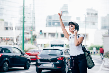 young woman calling taxi - obrazy, fototapety, plakaty