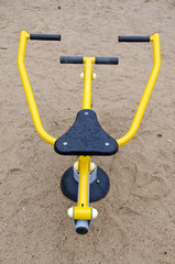Black and yellow exercise equipment in playground