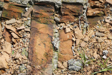 Damaged red brick from wall
