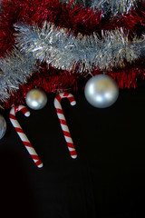 Christmas decoration composition tinsel baubles and candy canes