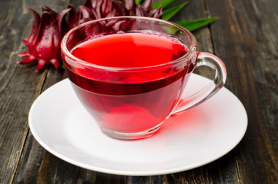 Fresh roselle juice (healthy drink) on wooden background