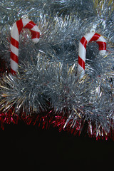 Christmas decoration composition candy cane with tinsel background