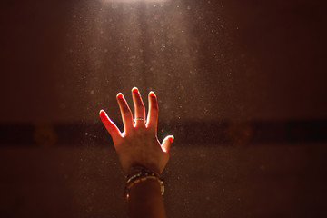 Woman hand into the light - 96169402