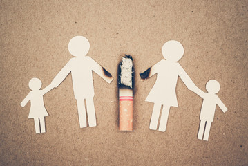 paper cut of family destroyed by cigarettes / drugs destroying family concept