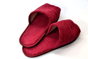 Red slipper on white background on top view