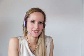 Portrait of attractive smiling blonde woman with headset.