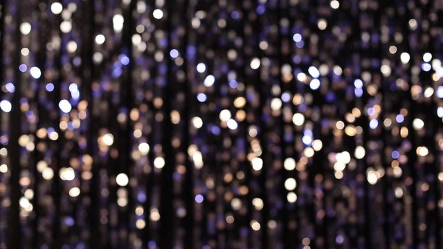 Abstract glittering lights, silver background, a real shot video in the blur
