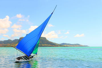 Sailboat in Mahebourg bay with Morne Brabant on background. Mauritius island.