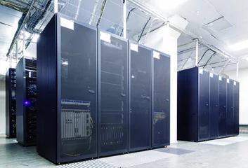 room with rows of server hardware in the data center © vladimircaribb
