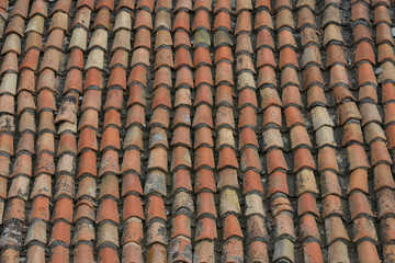 Close-up view of old tiled roof as background.