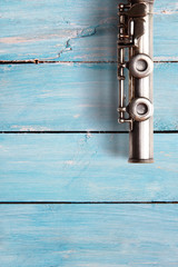 Old flute on blue wooden boards
