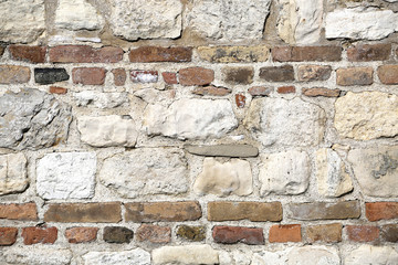 Stone wall with red bricks in like a flour or ceiling
