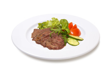 veal in wine sauce with vegetables on a white background