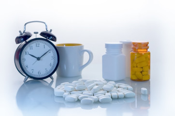 daily pills with clock and water