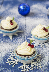 Chocolate cupcake with cream cheese in Christmas decorations