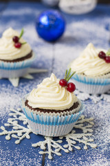 Chocolate cupcake with cream cheese in Christmas decorations