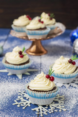 Chocolate cupcake with cream cheese in Christmas decorations