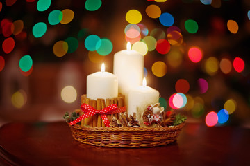 Christmas candles and ornaments over dark background  of de-focu