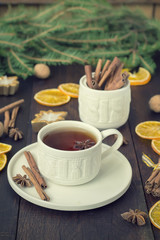tea with spices in a ceramic cup with Christmas decorations