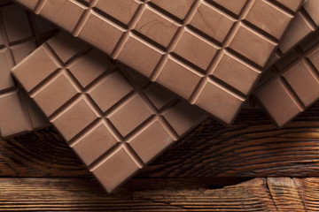 Chocolate bars on old wooden wall