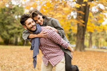 Fototapeta premium Young couple in the autumn forest