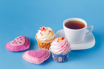 Heart symbol with cupcakes and tea