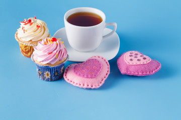 Heart symbol with cupcakes and tea