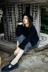 beautiful young woman lady posing outdoors wearing black hat