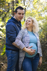 Fototapeta premium Young pregnant couple in the park