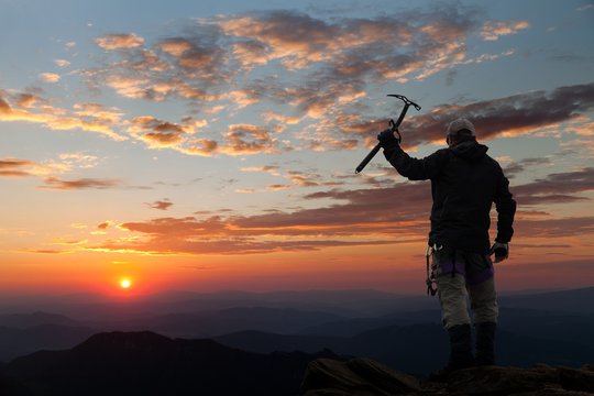 view of man on mountains with ice axe in hand
