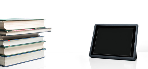 Books and tablet PC on a desktop