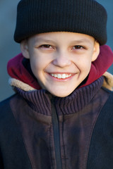 portrait of a little happy homeless boy